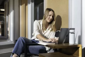 A female professional using a sales enablement system to reinforce best practices and enhance skill development